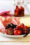 Antipasti platter with stuffed chilli peppers, olives, meat and cheese