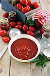 Freshly made tomato sauce in a bowl and in jars