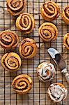 Cinnamon Buns on a Cooling Rack with Vanilla Icing