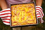 Woman Holding Fresh From the Oven Peach Cobbler
