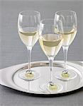 Three Glasses of White Wine with Name Tags on a Silver Tray