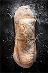 Two ciabatta rolls tied together with string (view from above)