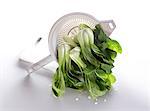 Wet pak choi in a sieve