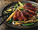 Glazed duck breast on a bed of stir-fried vegetables (Asia)