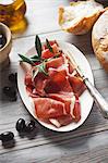 Serrano ham with bread and olives