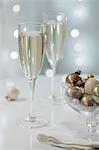 Two glasses of sparkling wine with Christmas decorations