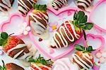 Chocolate dipped strawberries in pink hearts with sugar flowers