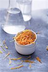 Dried marigold petals in a little bowl