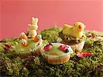 Muffins with marzipan decorations for Easter on moss