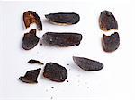 Slices of charred bread in front of white background