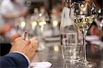 A glass of white wine on a reflective bar counter