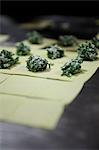 Raw squares of pasta dough, with spinach and ricotta mixture