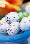 blue glass bowl of chocolate Easter eggs