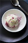 A scoop of blackberry and blueberry ice cream in a bowl