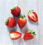 Strawberries on a wooden slab, viewed from above