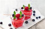 Raspberry and blueberry smoothies on a chopping board