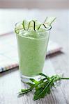 Rocket and cucumber smoothie on a wooden tabletop