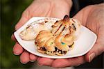 A Woman Holding a Small Dish of Sicilian Almond Pastries