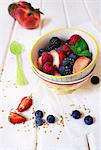 Colourful summer fruit salad with fresh mint and chopped nuts