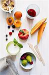 A still life of cereals, fruits, a glass of milk and fruit juice