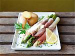 Asparagus wrapped in ham with Hollandaise sauce and potatoes