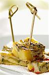 Spanish tortilla; made of eggs, potatoes, zucchini, garlic, chillies and fresh mint - cut and put on sticks