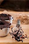 Chocolate melting middle puddings; an egg whisk with remnants of the raw mixture to one side