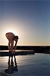 Man about to jump into a swimming pool