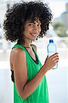 Portrait of a woman holding a water bottle and smiling