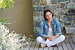 Woman sitting on a hardwood floor and day dreaming