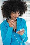 Smiling woman listening to music on a mobile phone