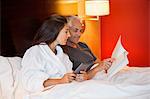 Couple reading a book in a hotel room