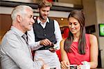 Couple paying with a credit card to a waiter in a restaurant