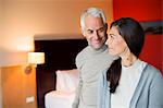 Couple smiling in a hotel room