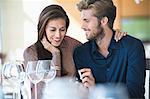 Man with engagement ring proposing his girlfriend in a restaurant