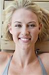 Portrait of a smiling woman resting in a sauna