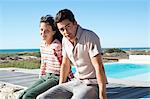 Couple sitting on a boardwalk on the beach