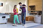 Father and daughter holding cleaning equipment and discussing