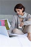 Woman working on a laptop and looking upset