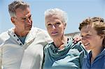 Boy with his grandparents on the beach