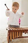 Baby boy playing a xylophone