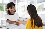 Real estate agent shaking hands with a woman