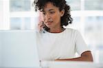 Woman working on a laptop at home