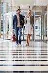 Smiling couple walking at an airport