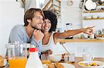 Smiling couple sitting at a dining table