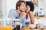 Smiling couple sitting at a dining table