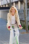 Portrait of a woman riding a bicycle and smiling