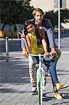 Portrait of a smiling couple riding a bicycle