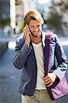 Man walking on a street and talking on a mobile phone