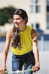 Woman riding a bicycle and smiling